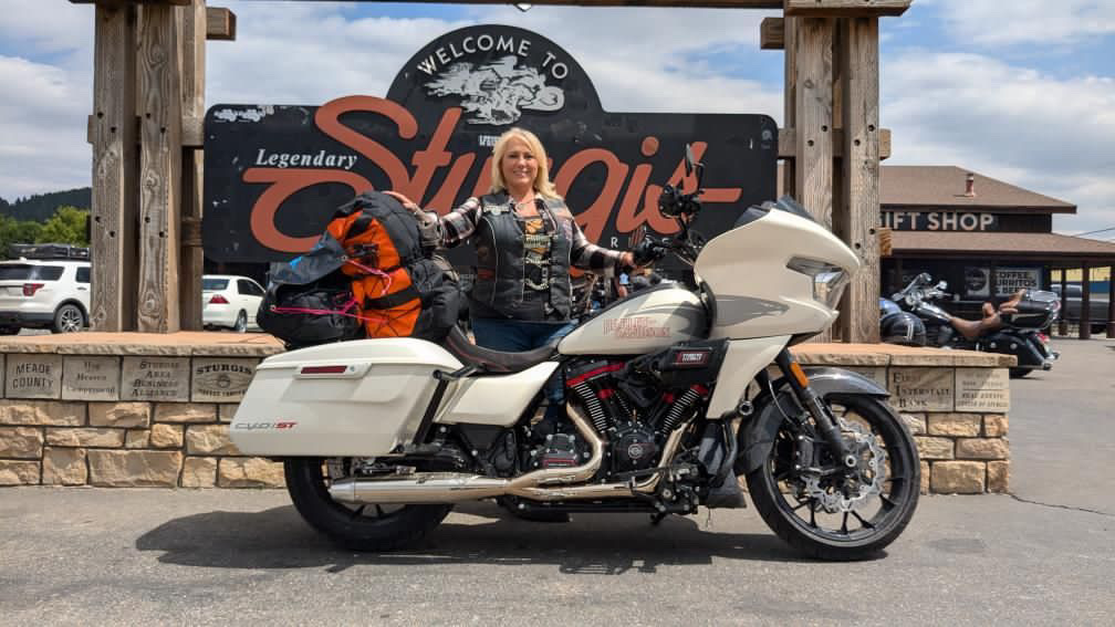 Throttle Forward founder Elizabeth Wahlberg standing behind her motorcycle in Sturgis